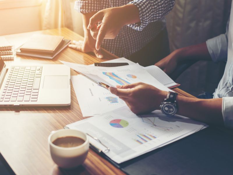 Accountant carefully reviewing financial reports and charts